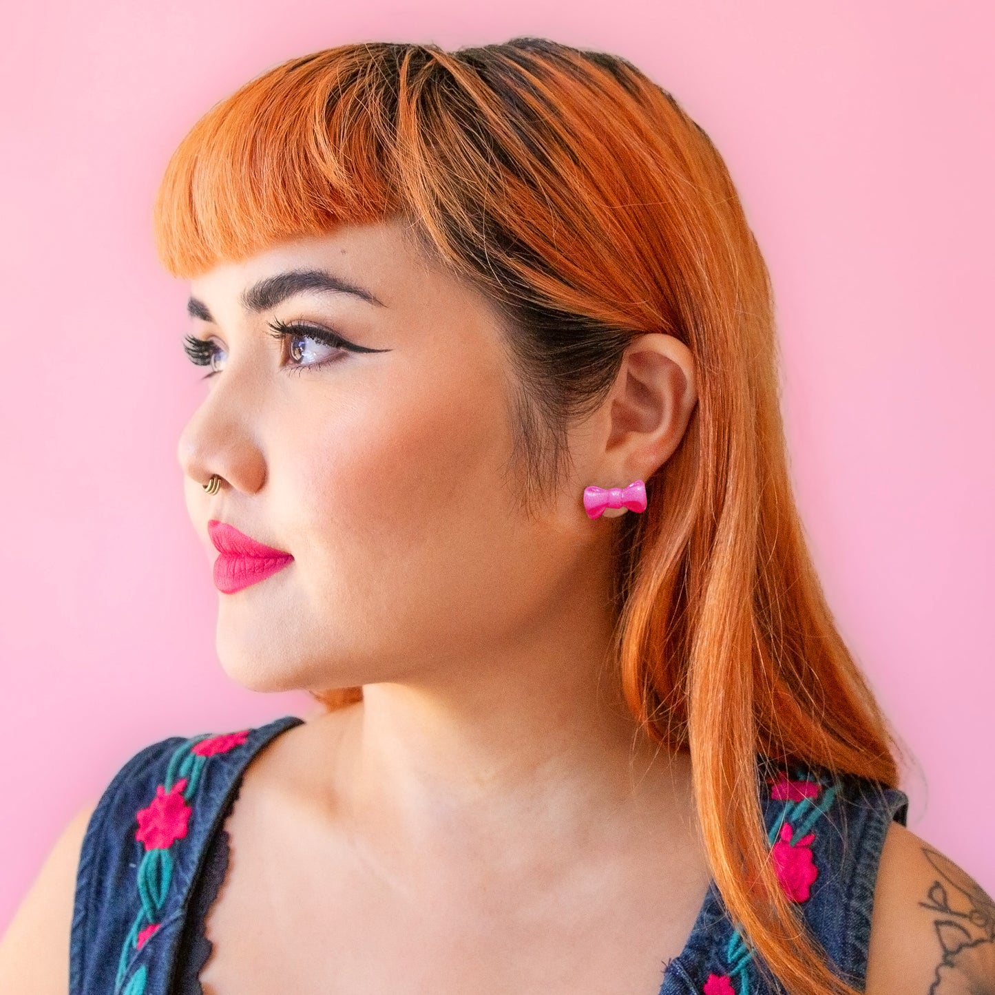 girl wearing pink bow earrings