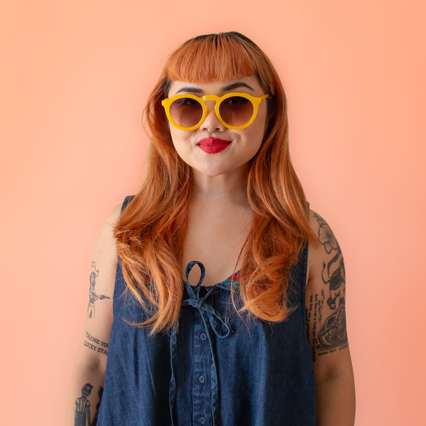 A pair of yellow round sunglasses with a brown gradient lens.