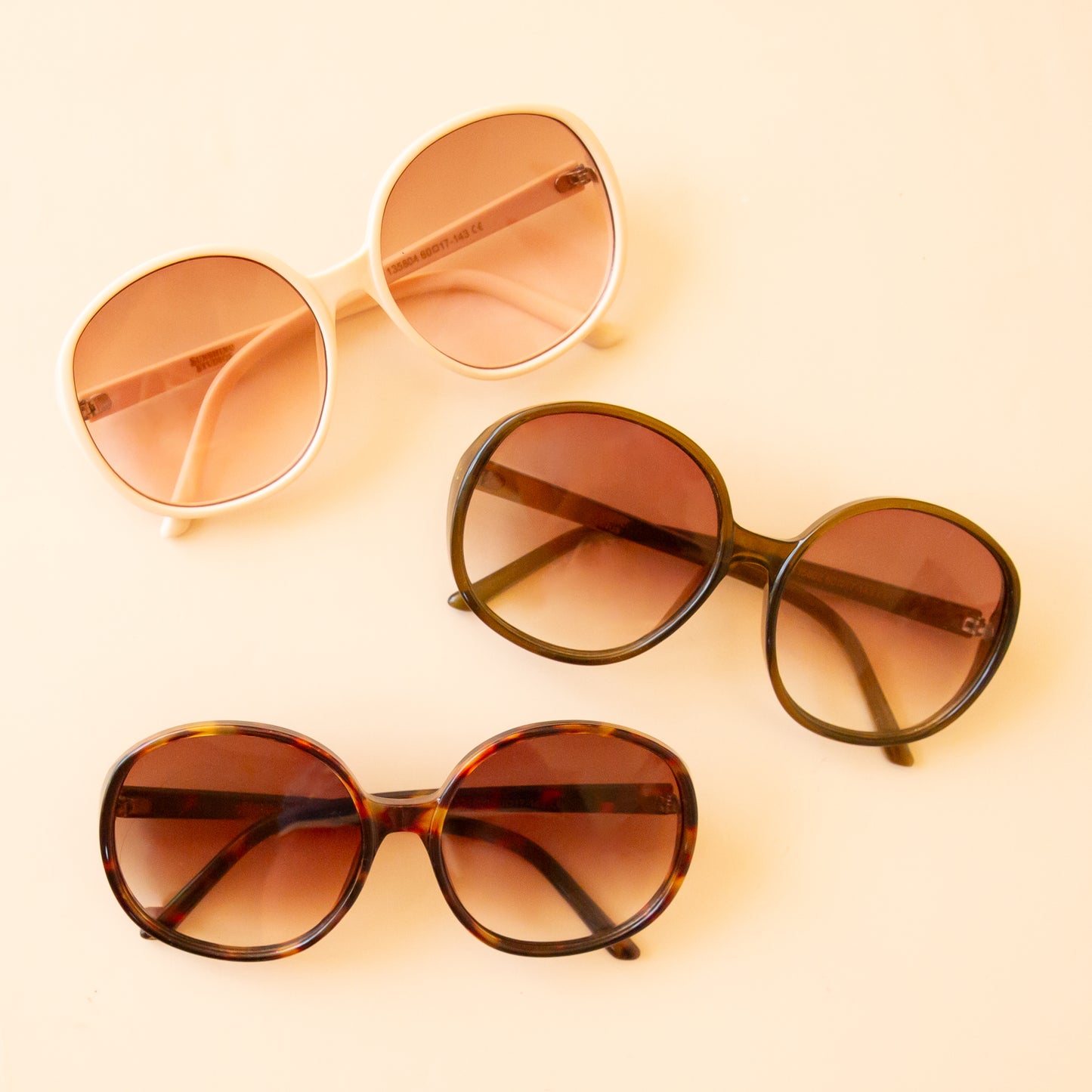 The three circle Bardot sunglasses in different colors. Ivory, Juniper and cognac.