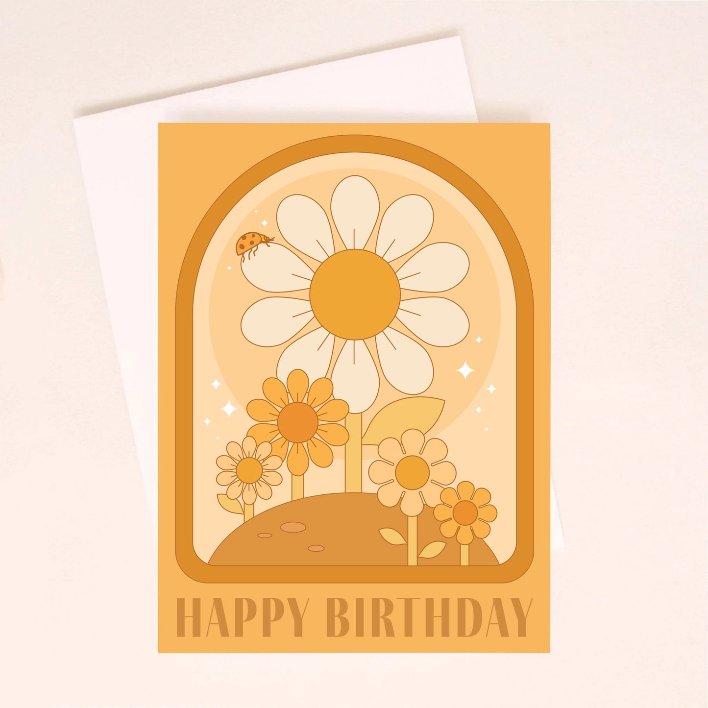 On an ivory background is an orange greeting card with a darker orange arched border and daisy illustrations inside along with text at the bottom that reads, "Happy Birthday". Also included is a white envelope.