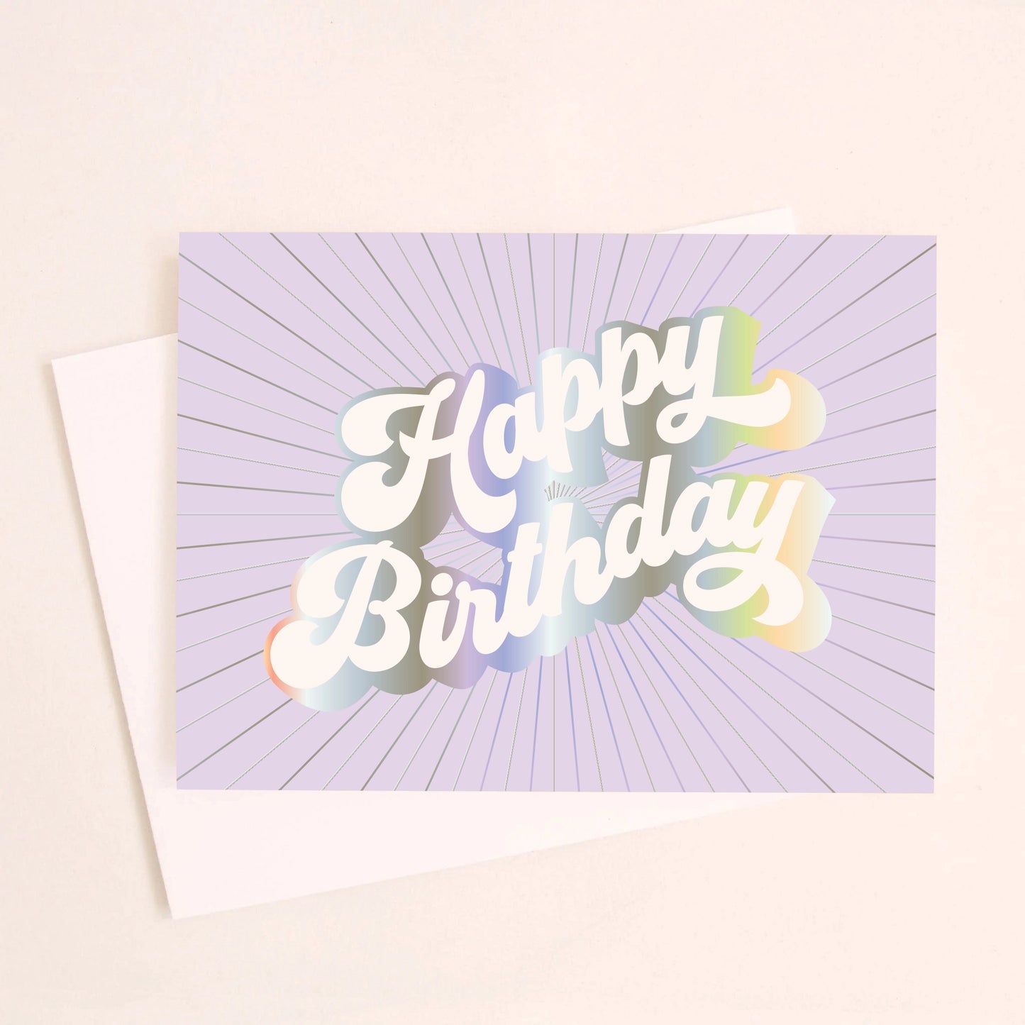 On an ivory background is a purple greeting card with white, holographic outlined text that reads, "Happy Birthday".