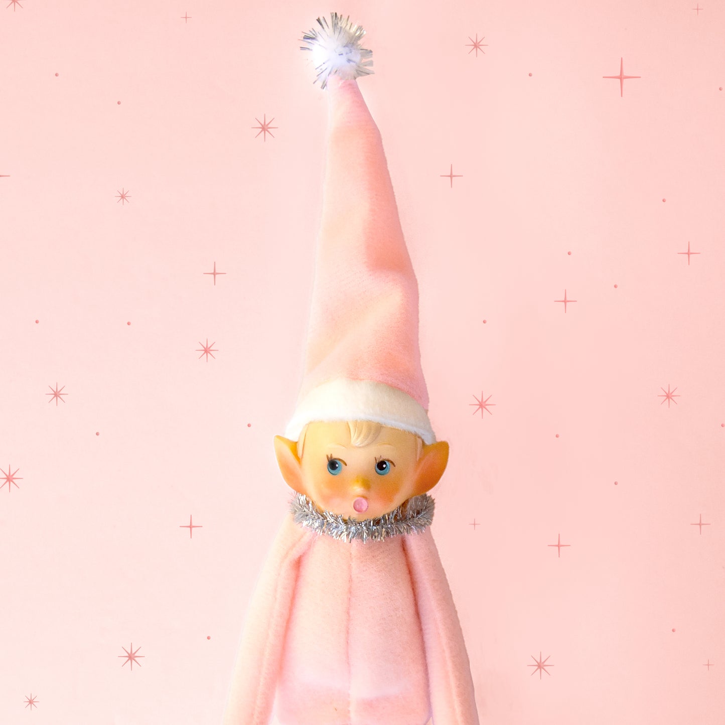 A light pink baby elf ornament.