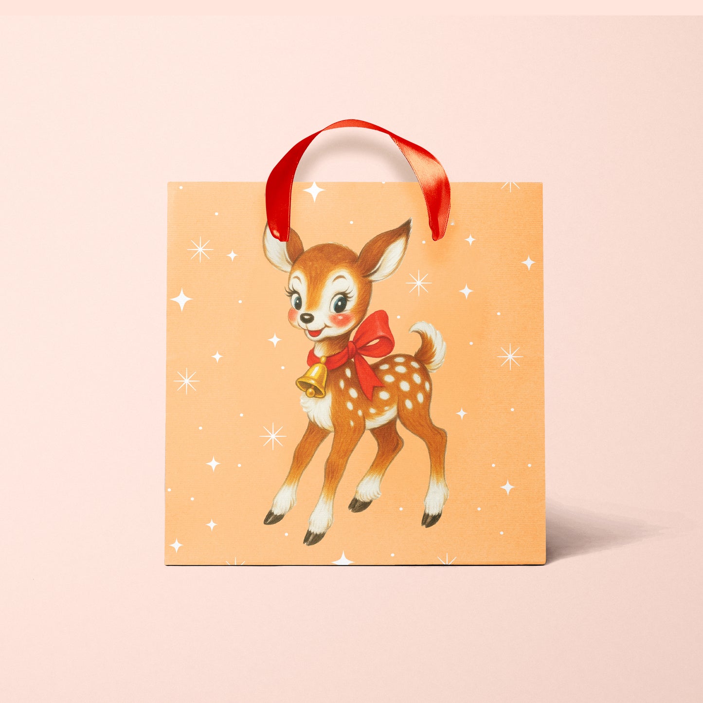 An orange gift bag with a retro deer graphic and red ribbon handles.