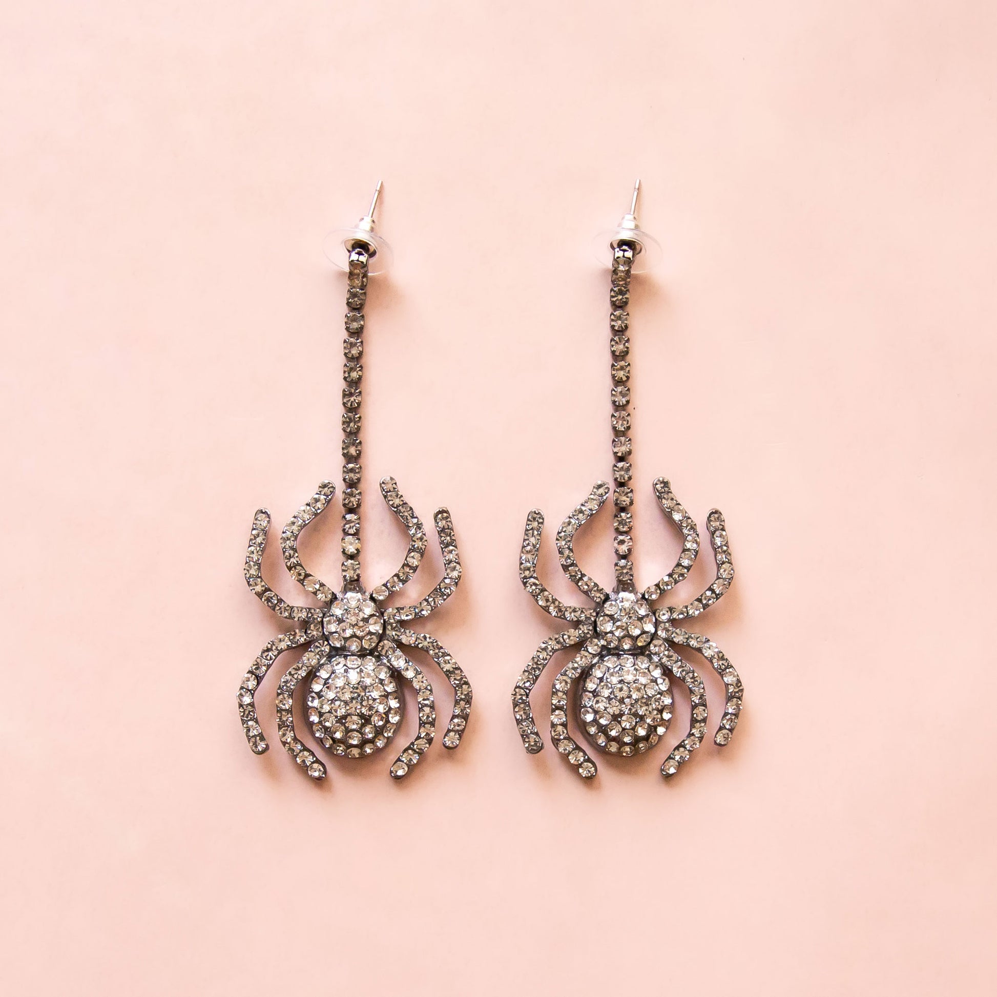 Dangling black spider earrings with CZ stones.