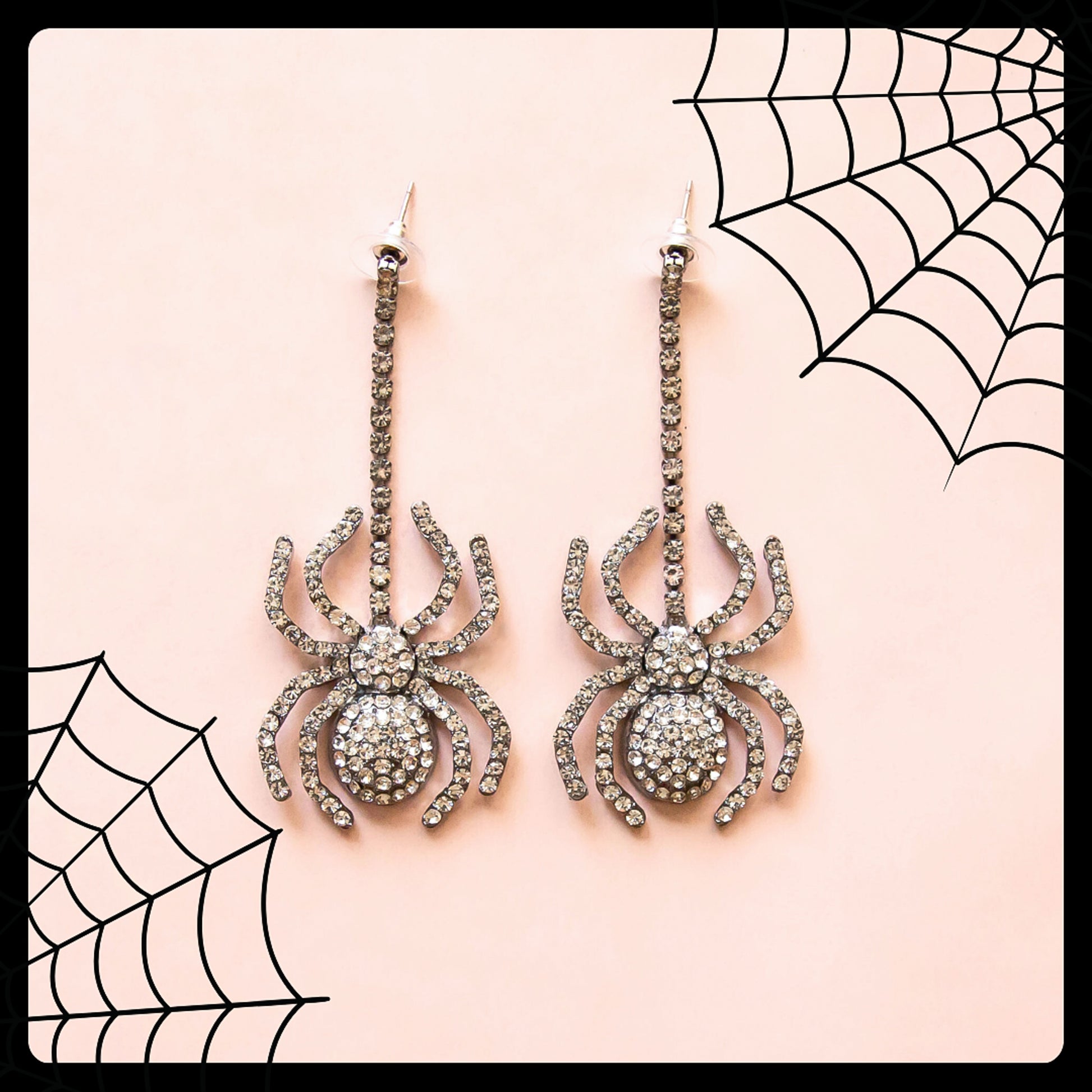 Dangling black spider earrings with CZ stones.