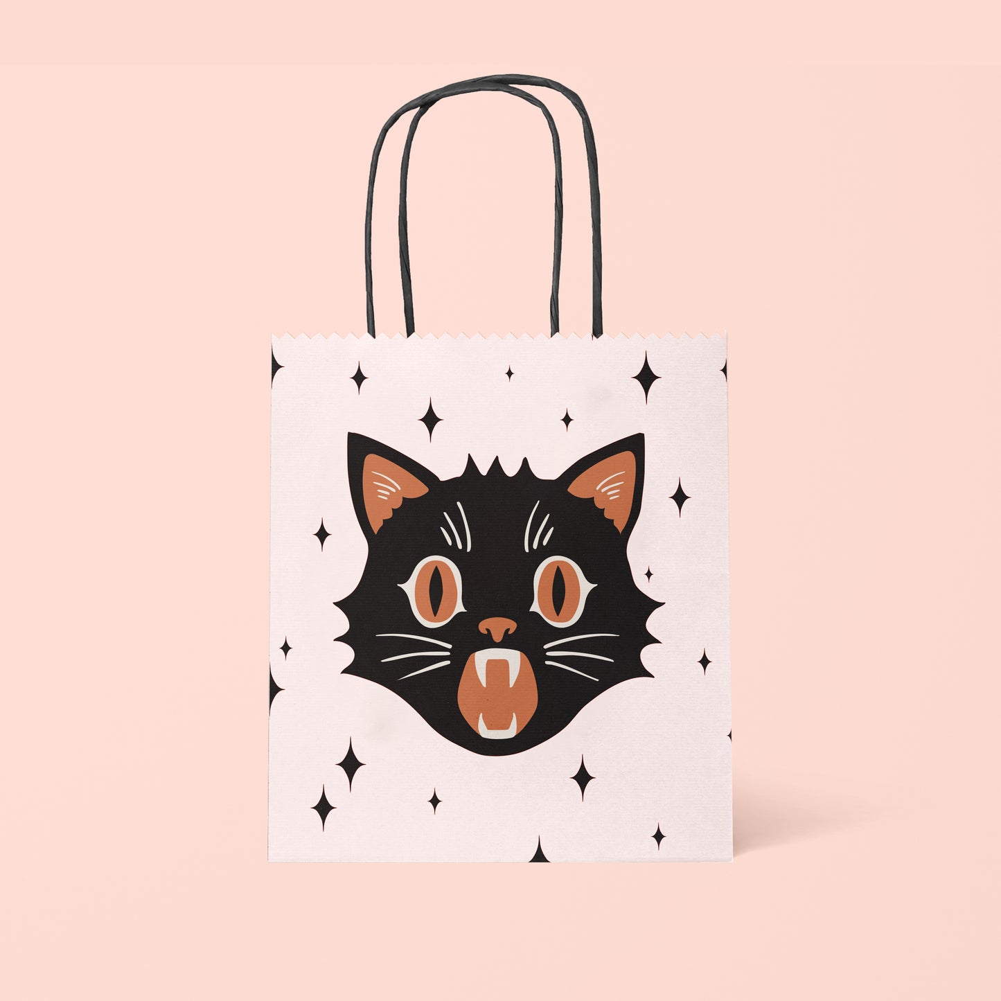 Light pink gift bag with a black and orange cat face and black stars.