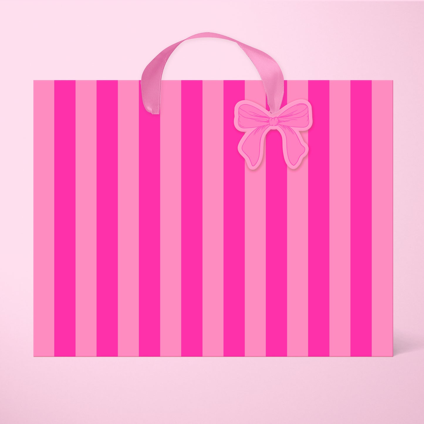 A light pink and hot pink striped gift bag in two different sizes with ribbon handles and a small bow shaped tag.