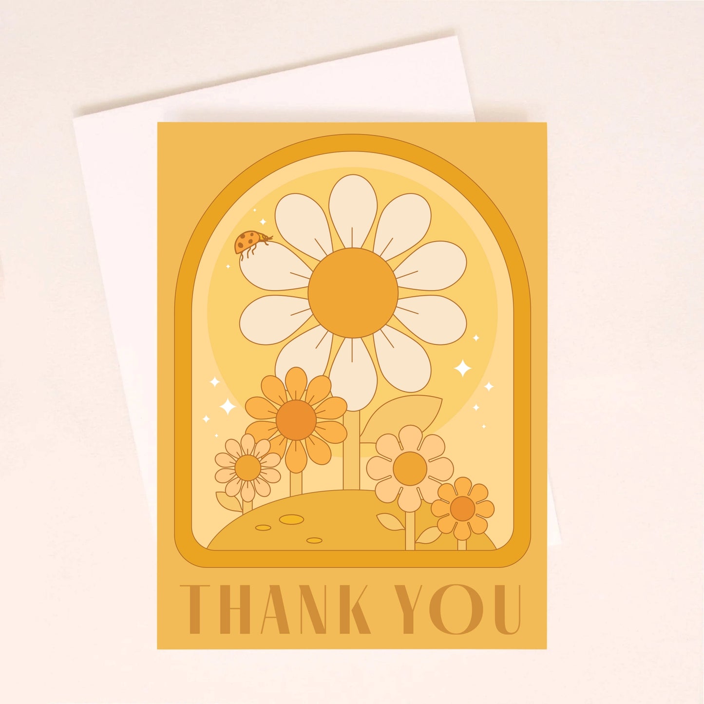 On an ivory background is an orange greeting card with an arch and daisy design with a small ladybug sitting on the largest daisy as well as dark orange text along the bottom the reads, "Thank You".