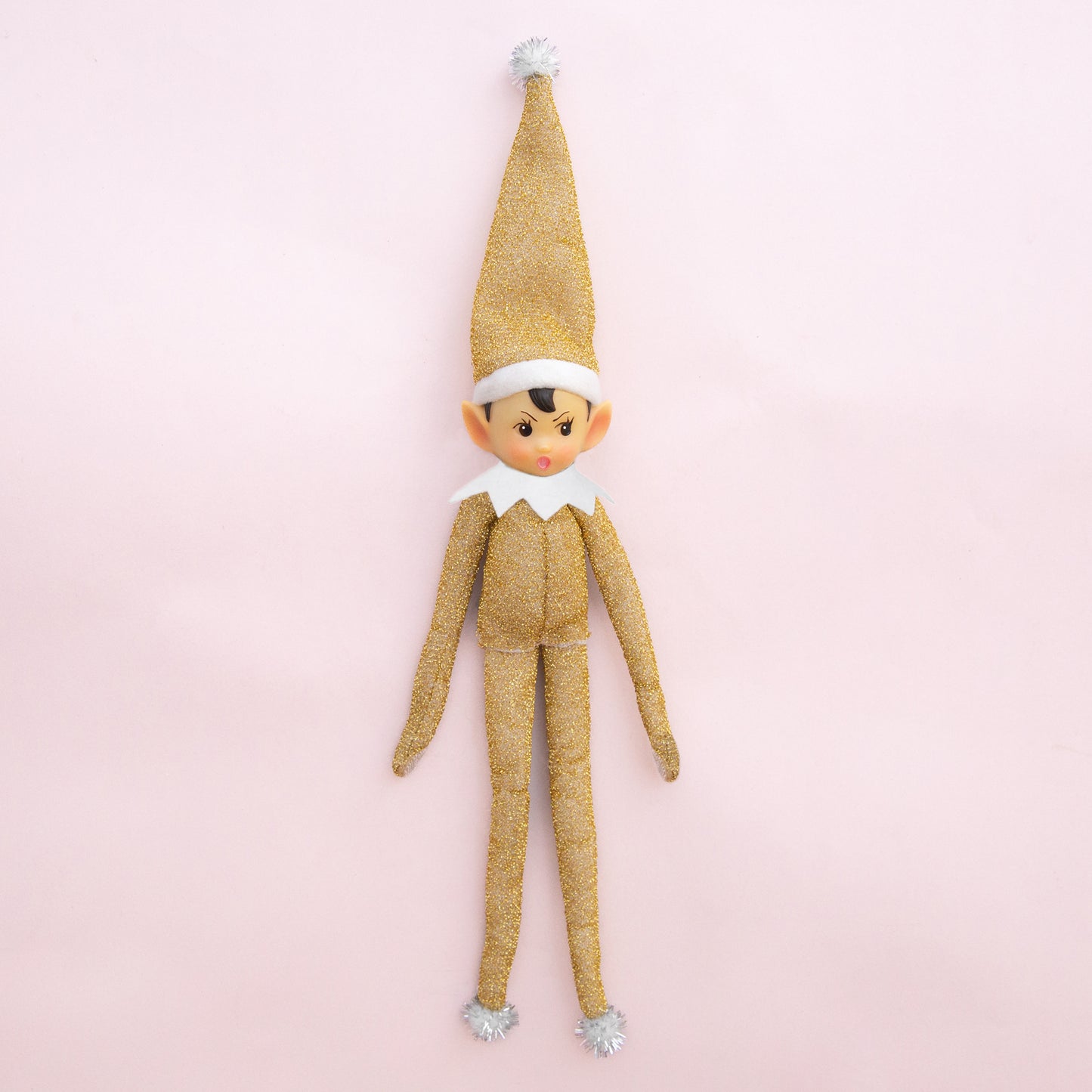 A gold sparkled elf shaped ornament.