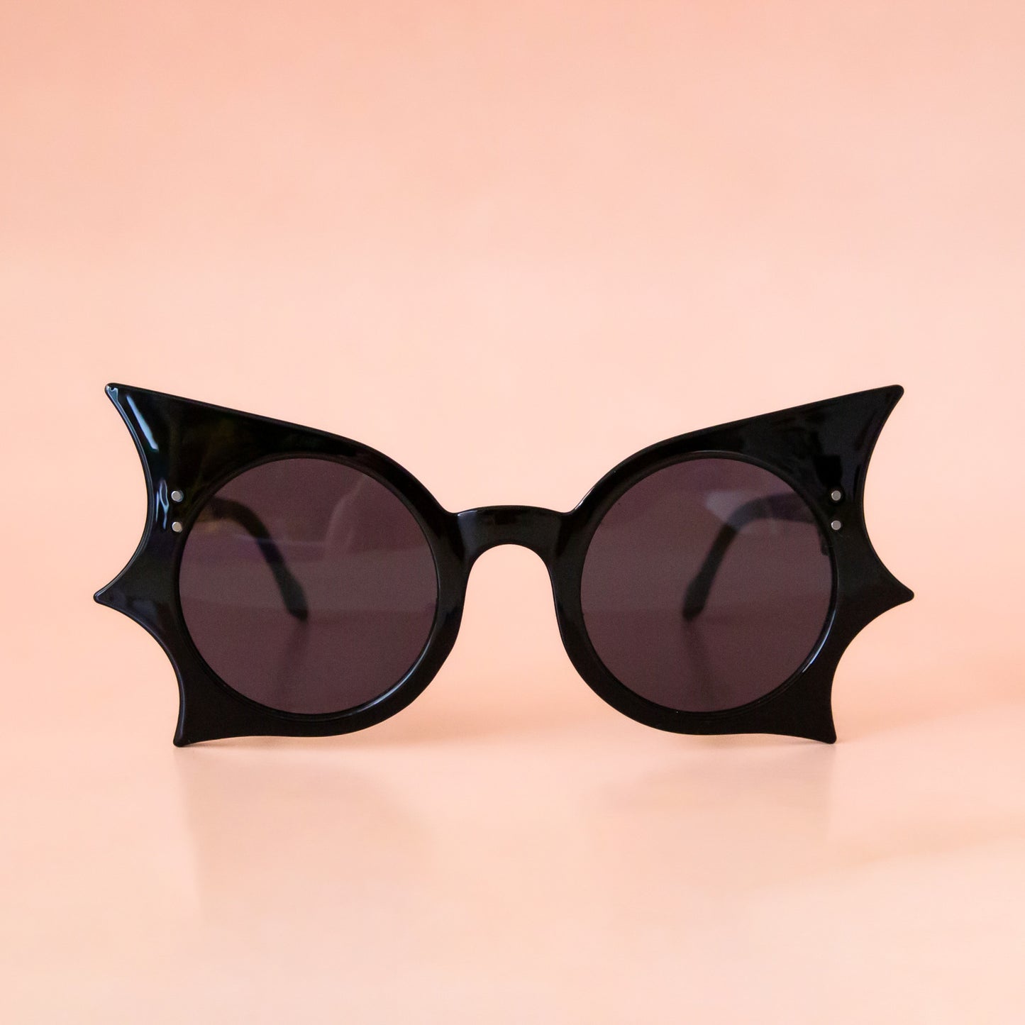 Black sunglasses with bat wing details around the edges of the frames.