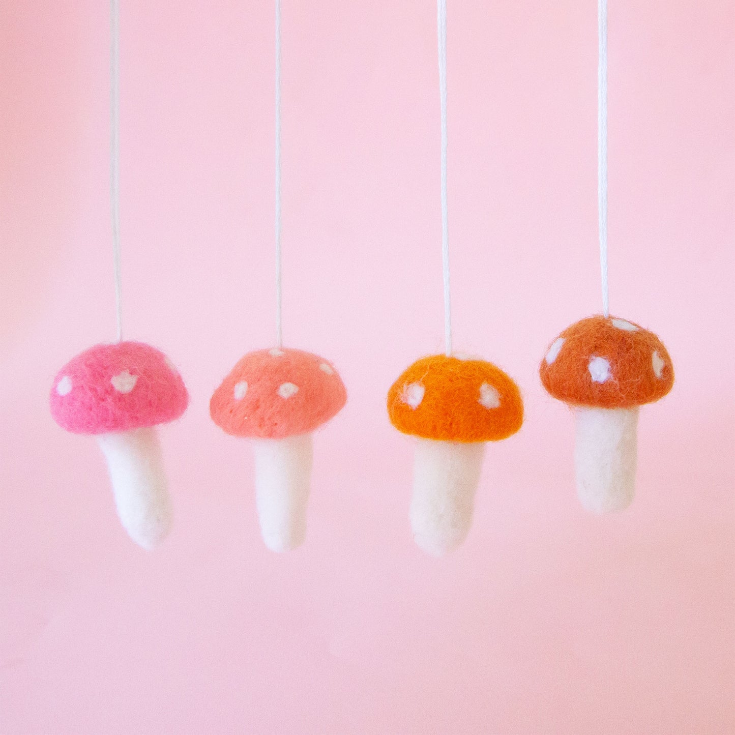 Different colored felt mushroom shaped ornaments.