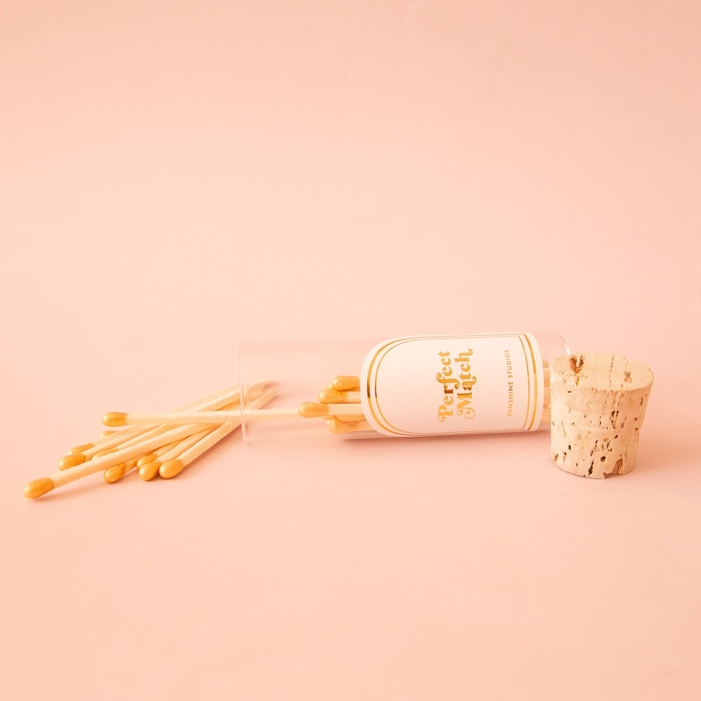 A small glass vial of wooden matches with a label that reads, 'Perfect Match'.