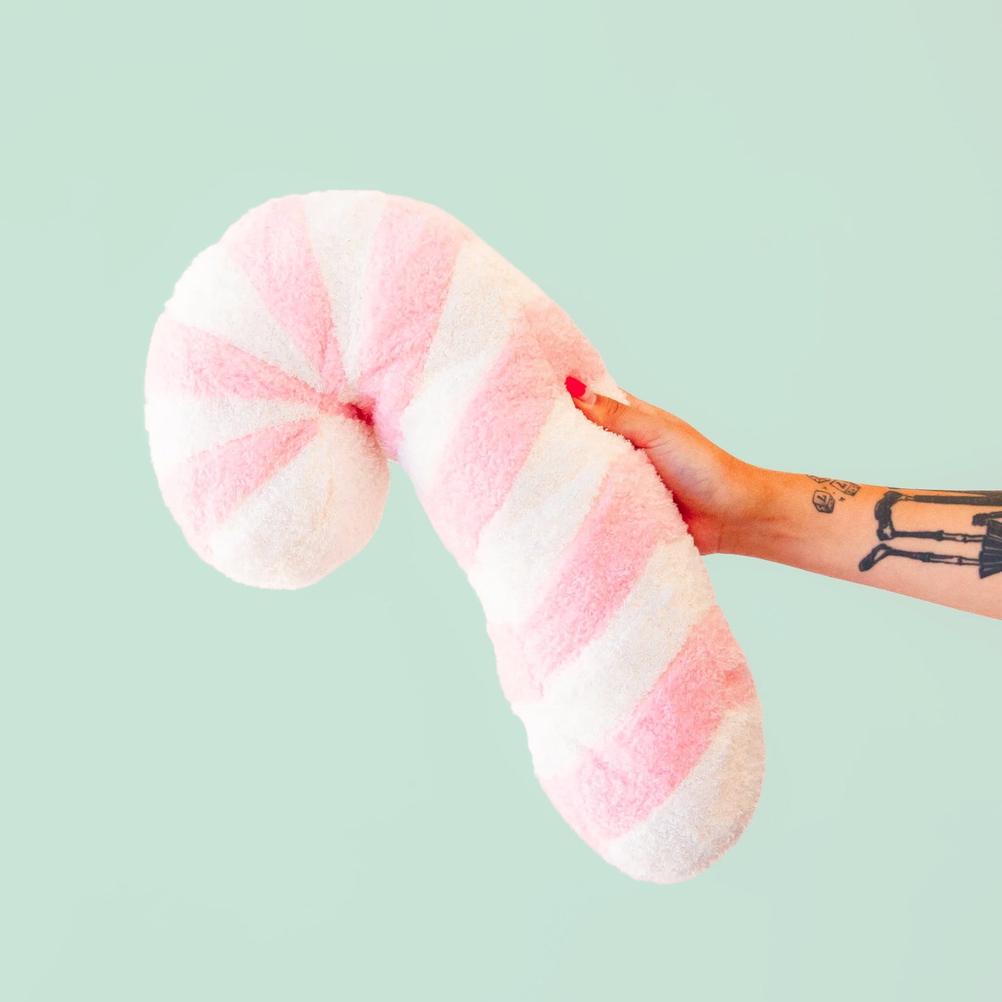 A light pink and white circle swirl pillow.