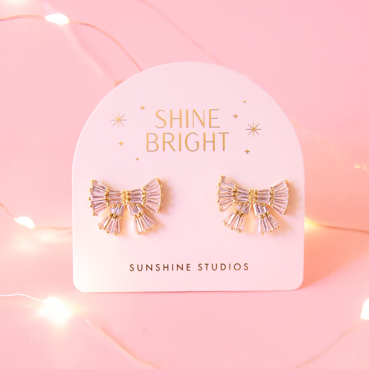 CZ baguette bow earrings with gold detailing
