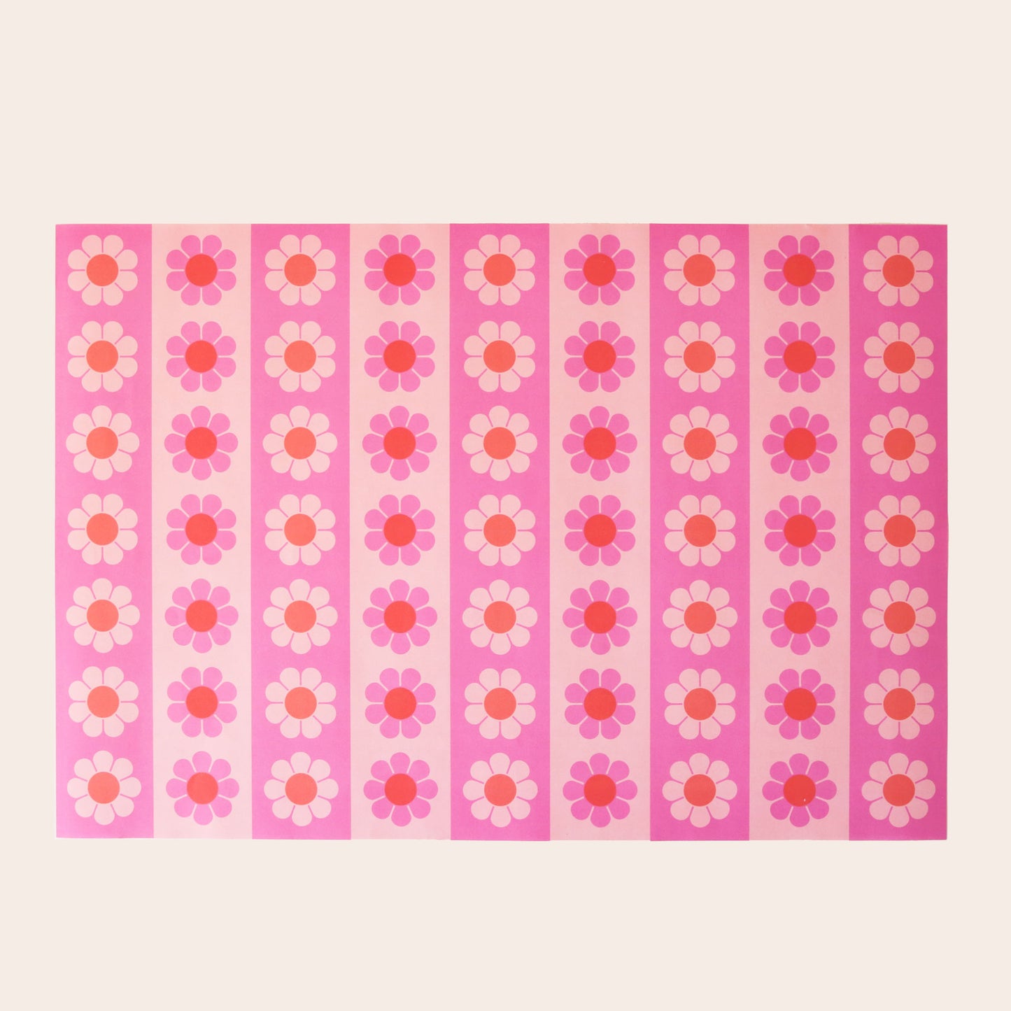 Sheet of wrapping paper filled with vertical stripes of pink and orange flowers.