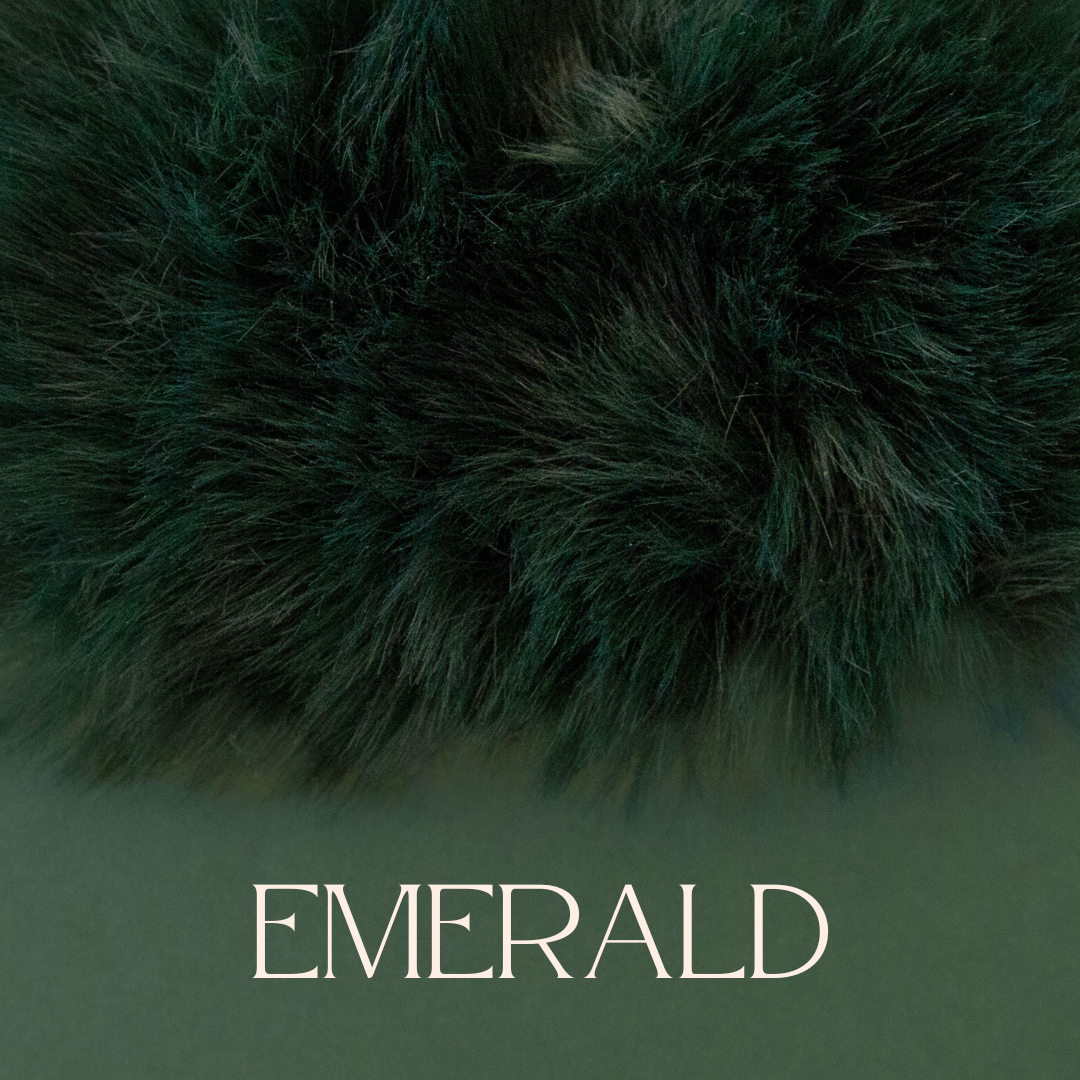 A dark green white faux fur blanket. 