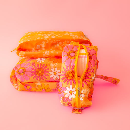 orange packing pouches with pink and ivory 70's floral design