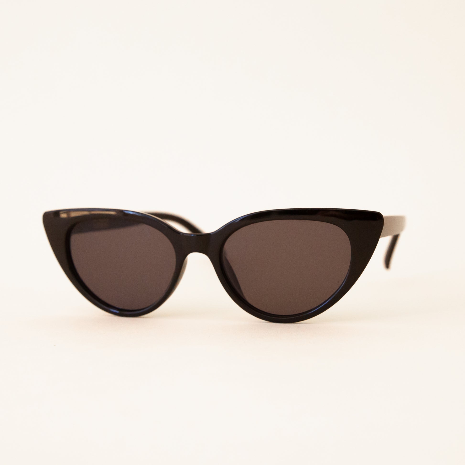 A black pair of cat-eye shaped sunglasses.