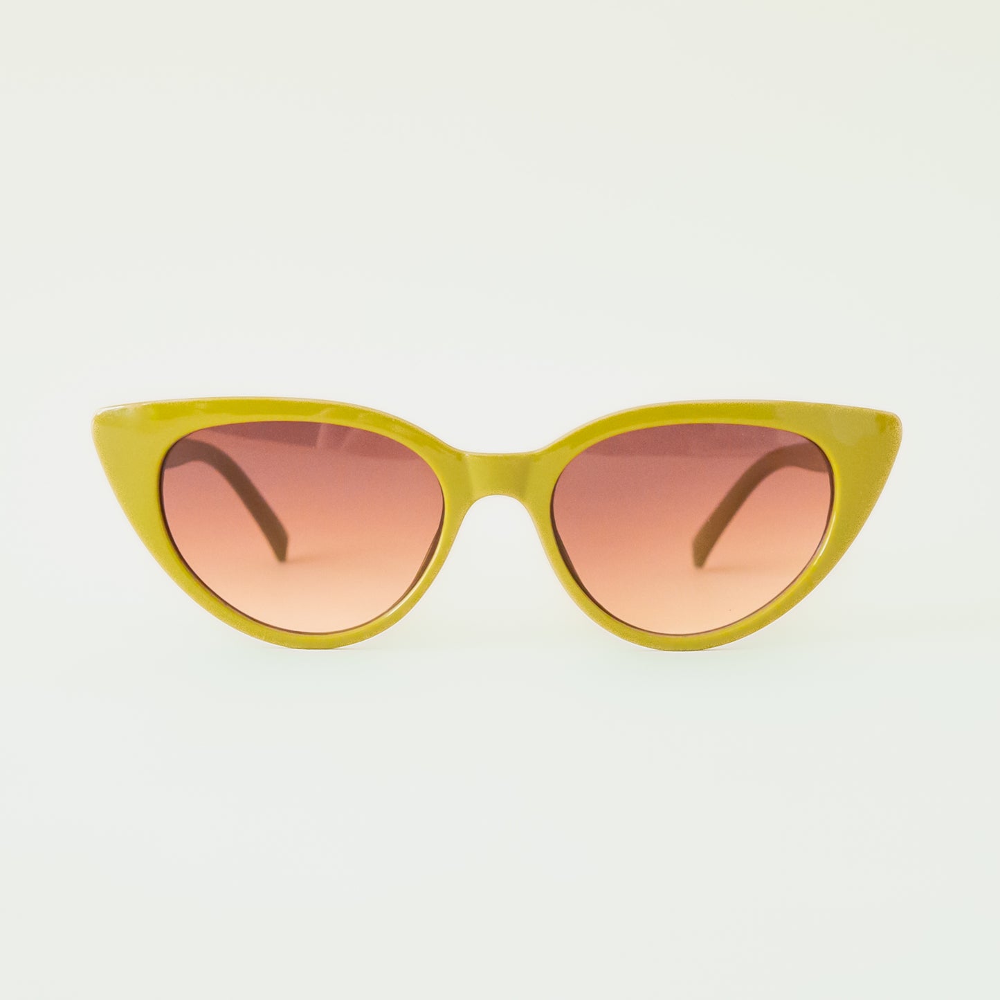 A green pair of cat-eye shaped sunglasses with a brown lens.