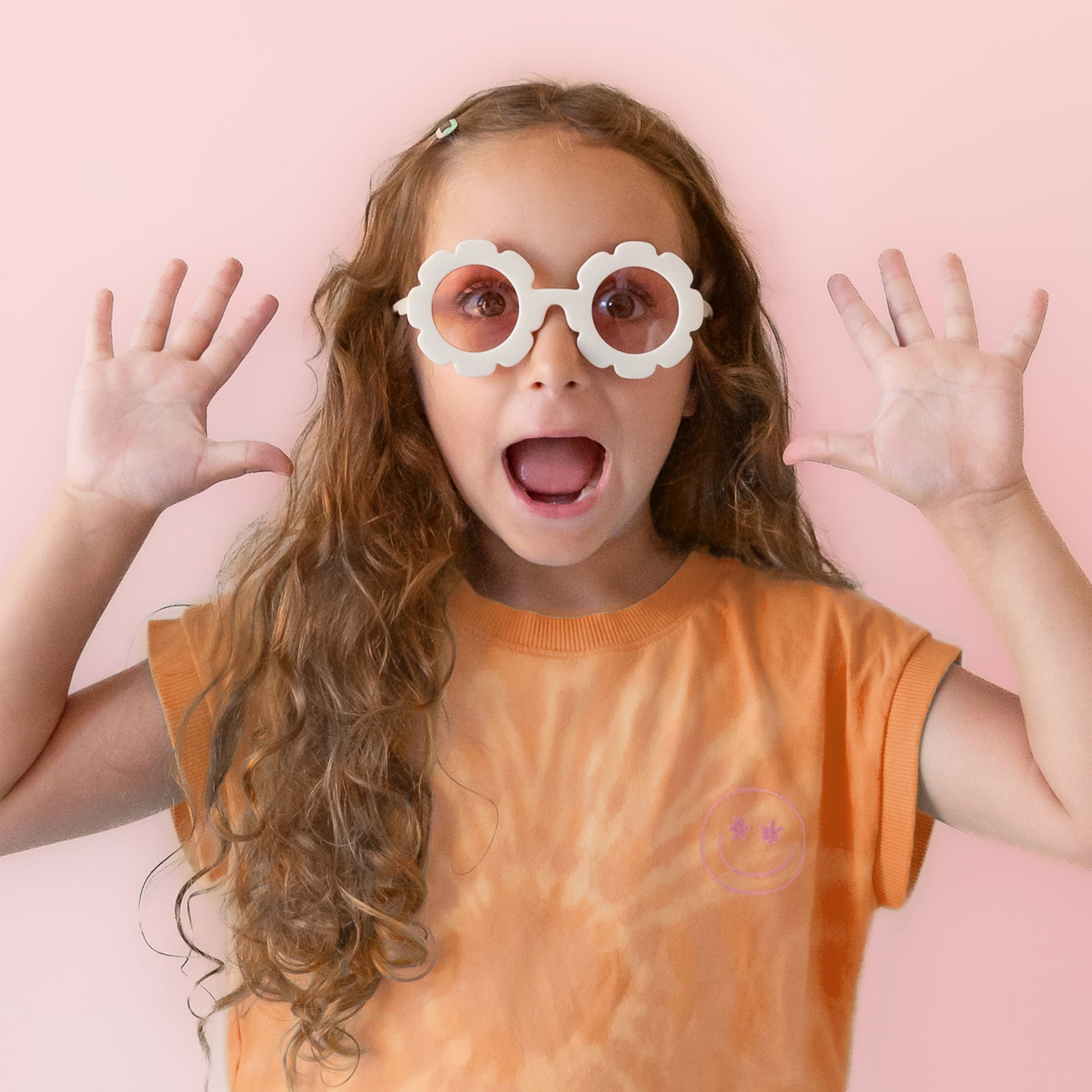 White flower sunglasses with a pink lens.