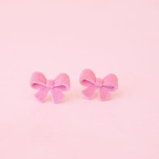 Pair of pink bow earrings.