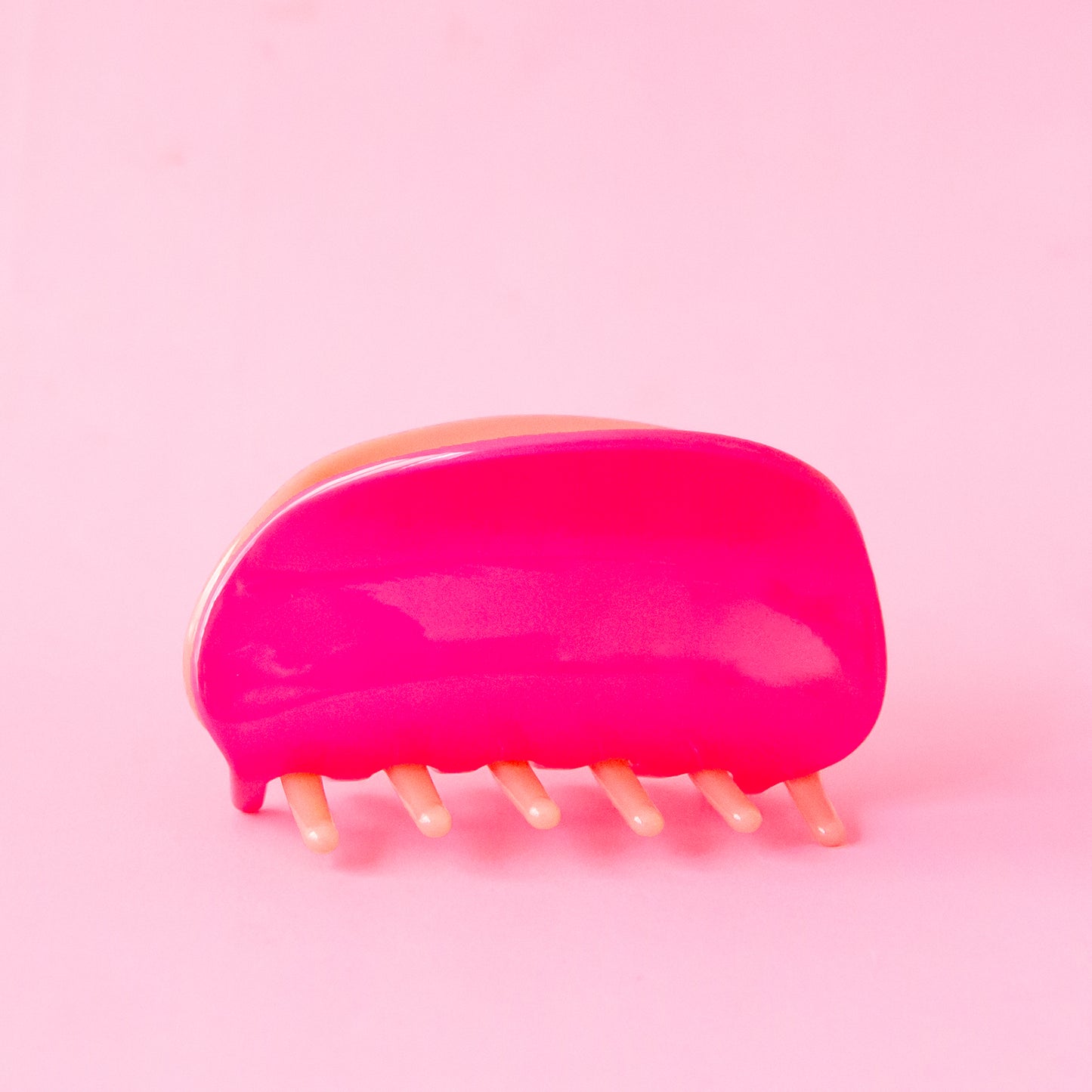 A two-toned, pink and light pink claw clip with rounded edges.