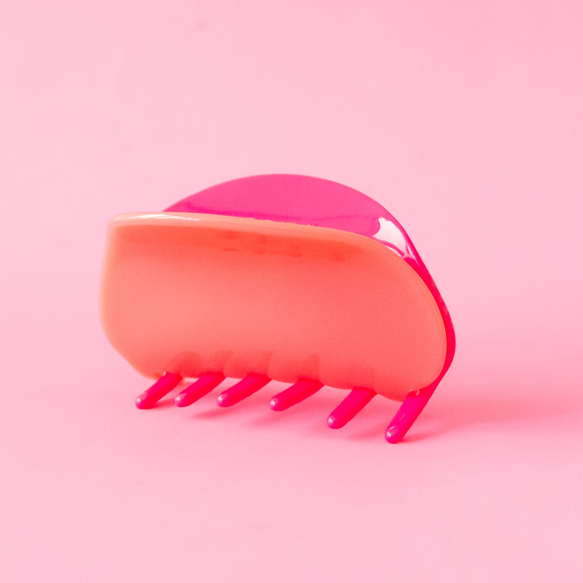 A two-toned, pink and light pink claw clip with rounded edges. 