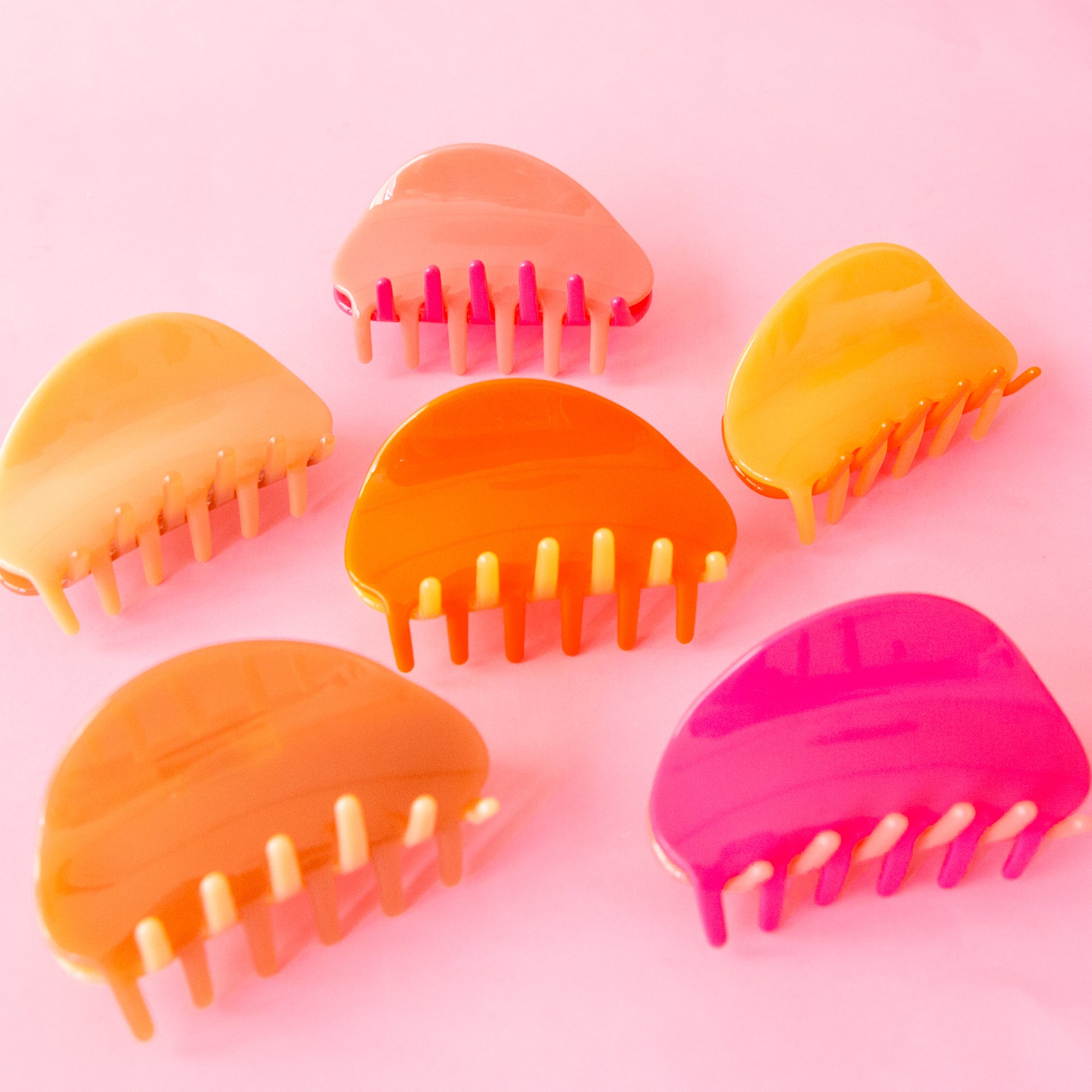 All three of our two-toned claw clips side by side in tones of pink and orange.