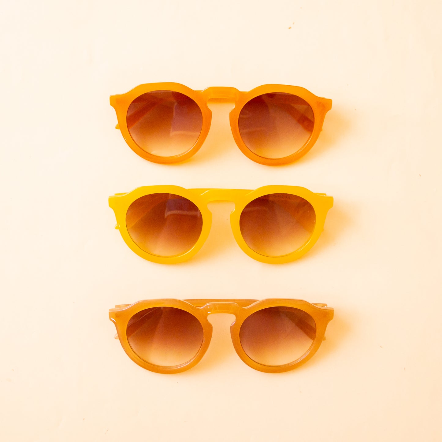 All three color ways of our Sloane sunglasses that range from orange, to yellow to warm brown. 