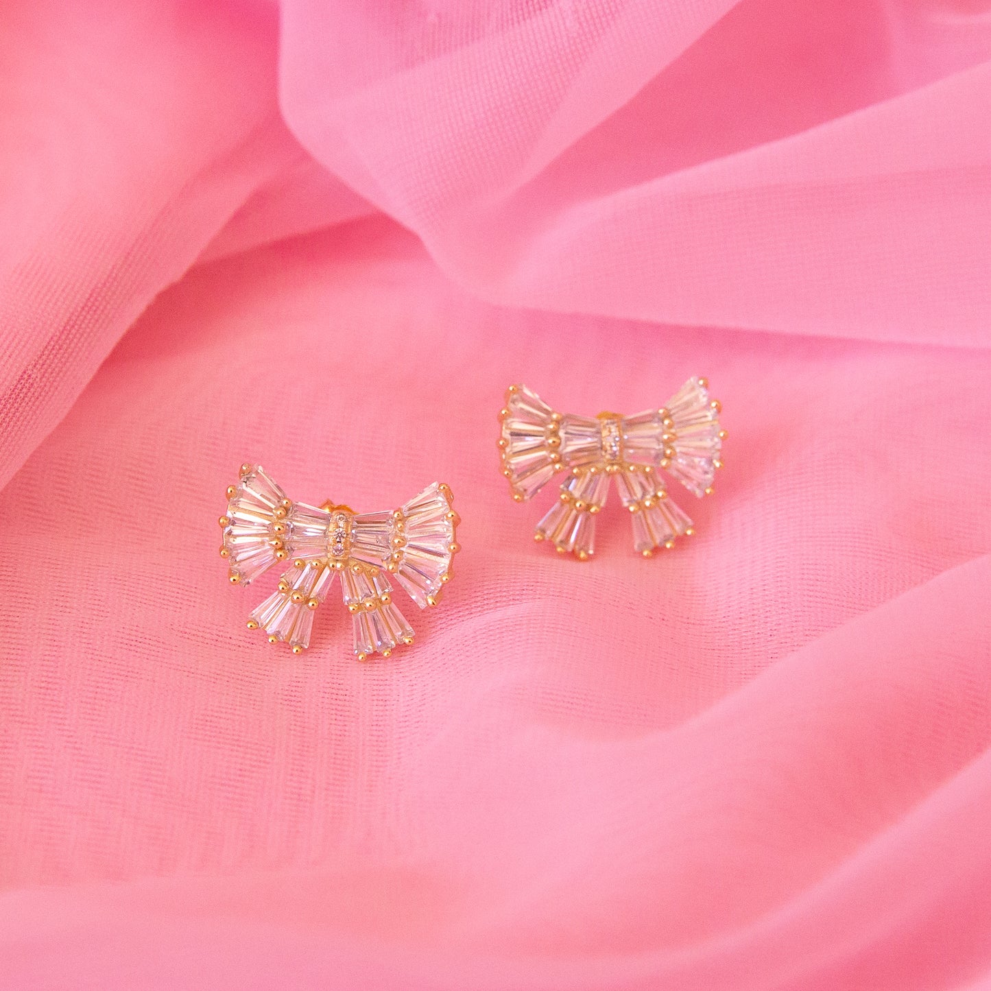 CZ baguette bow earrings with gold detailing