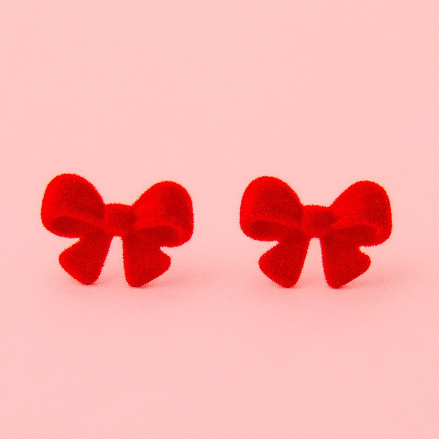 Flocked red bow earrings.