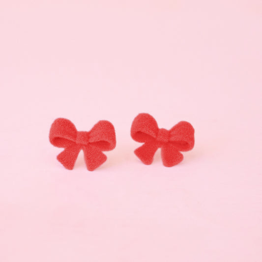 Pair of red bow earrings. 