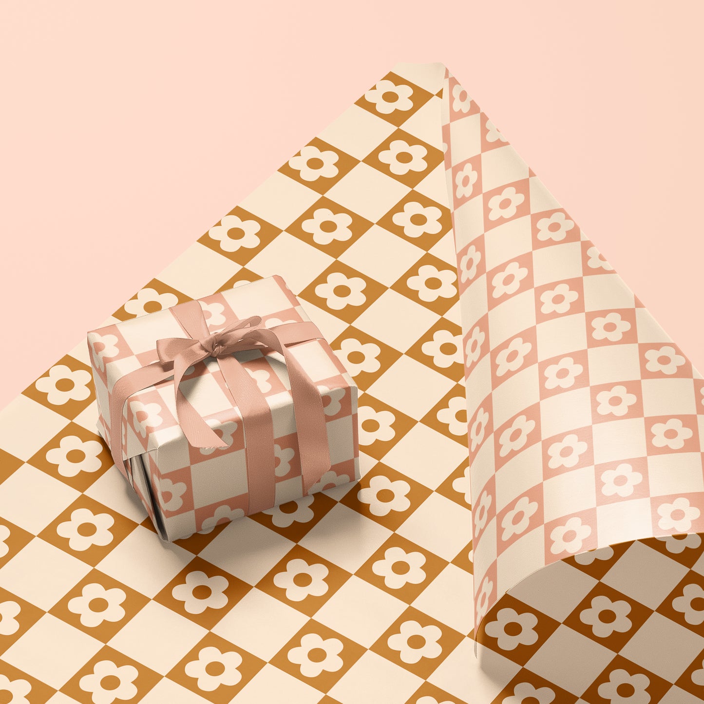 A single sheet of gift wrap with a checker print that has white daisies inside of each square. This gift wrap is reversible and features a white and rust checker print on one side and a light mauve and white print on the other.