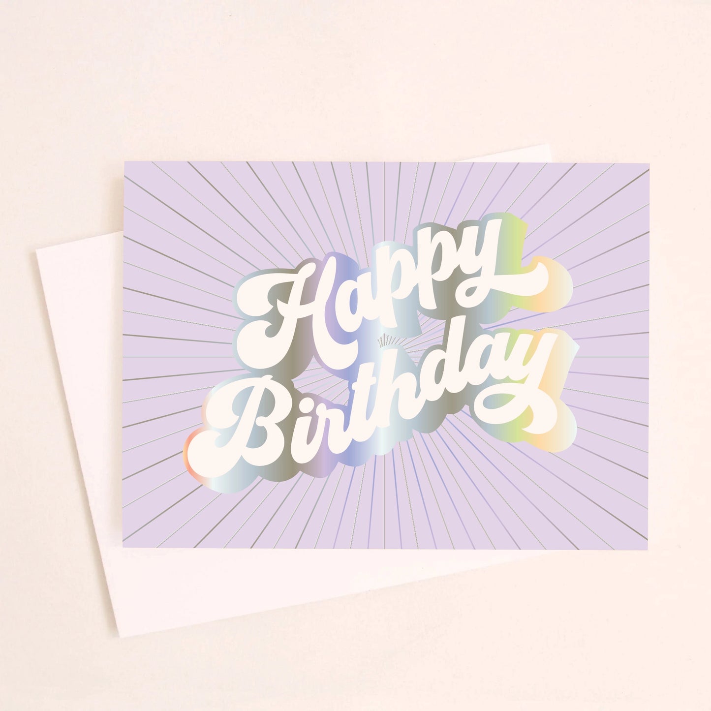On an ivory background is a purple greeting card with white, holographic outlined text that reads, "Happy Birthday". 