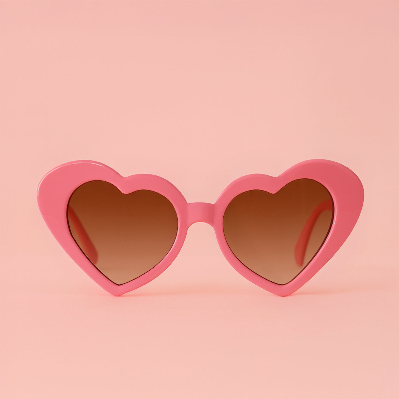 A pink heart shaped pair of sunglasses. 