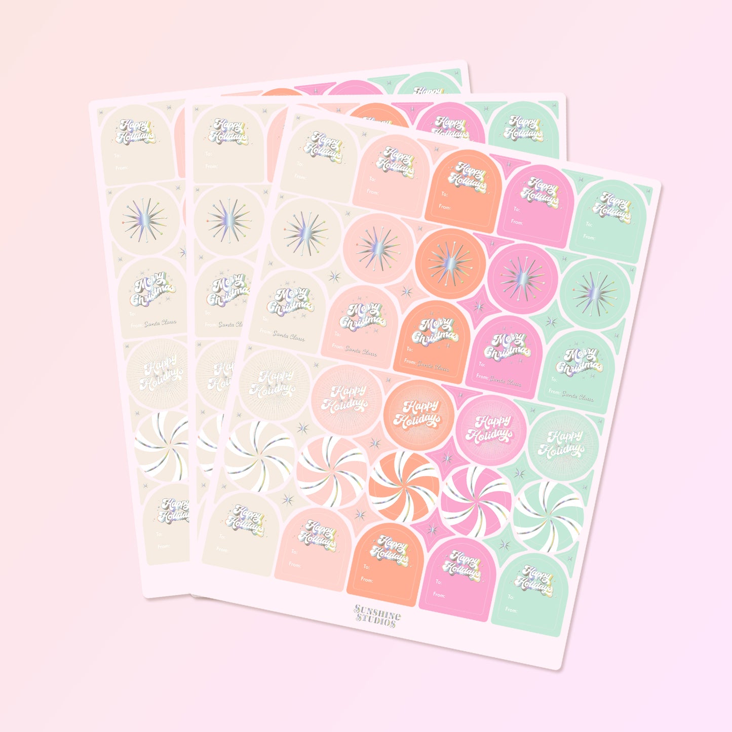 On a pink background is three sheets of gift labels with shades of pink, orange, mint and ivory along with holographic text and designs. 