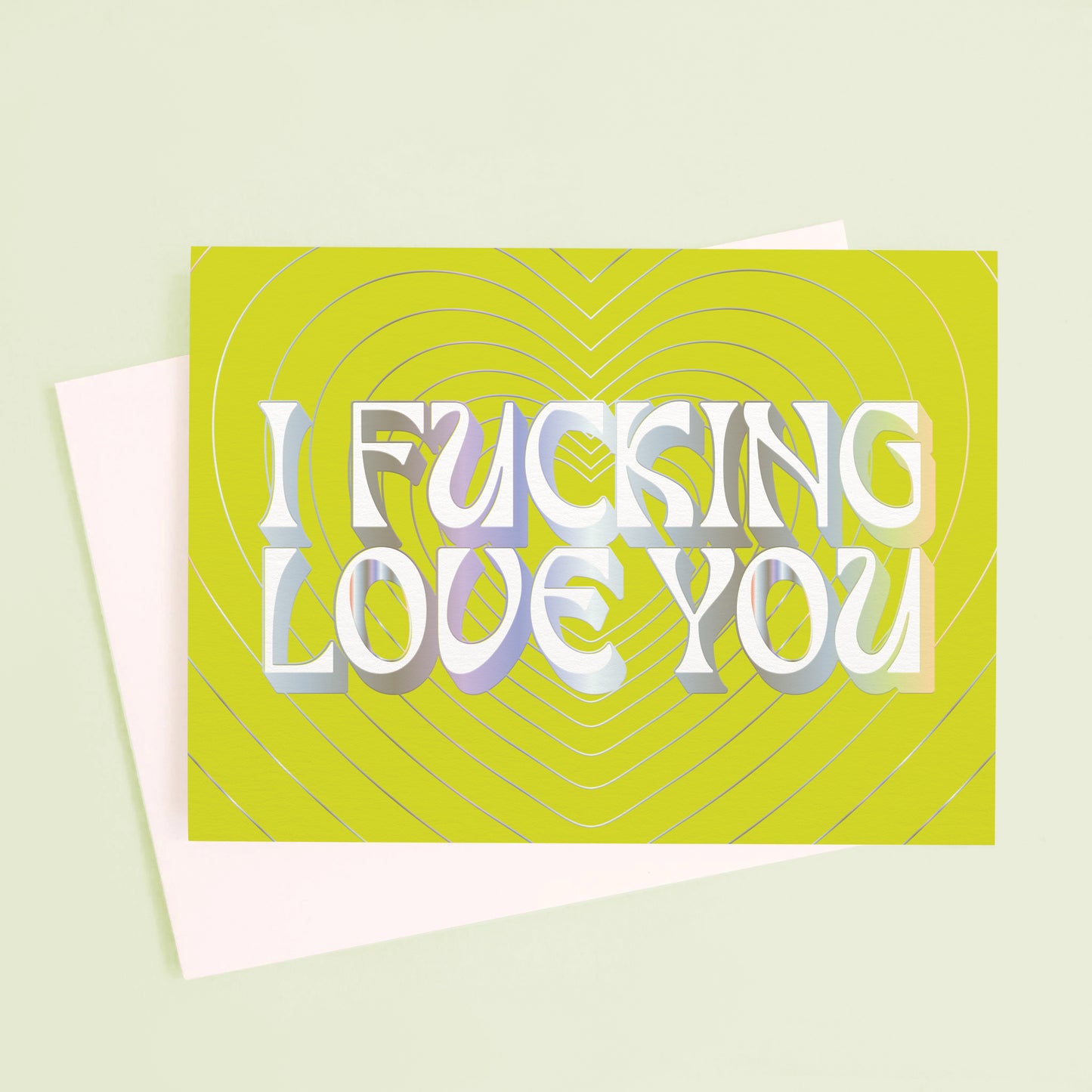 On a mint green background is a lime green card with silver heart shapes and text in the center that reads, "I Fucking Love You". 