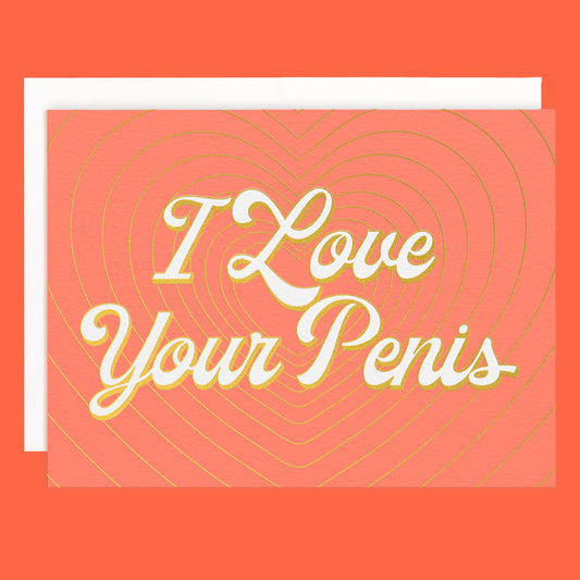 On a peachy background is a peachy colored card with layered gold foiled hearts and ivory text that reads, "I Love Your Penis" along with a white envelope.