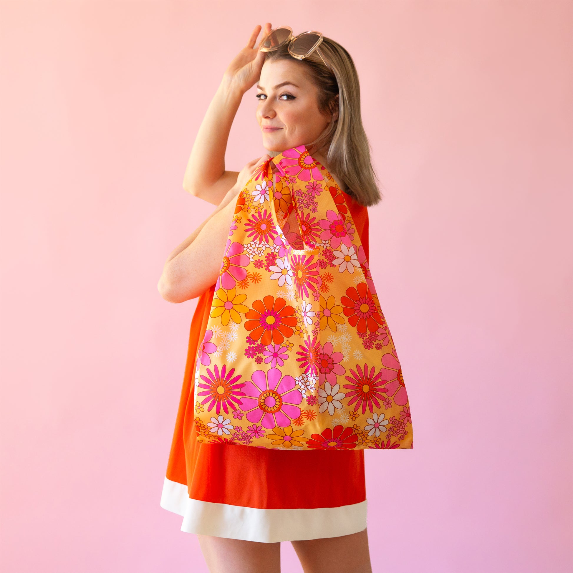 A pink, yellow and ivory nylon reusable bag. 