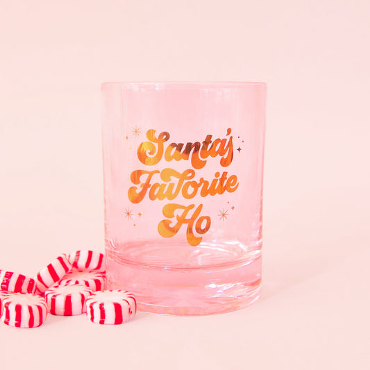 pink glass tumbler with gold script font that says "santa's favorite ho"