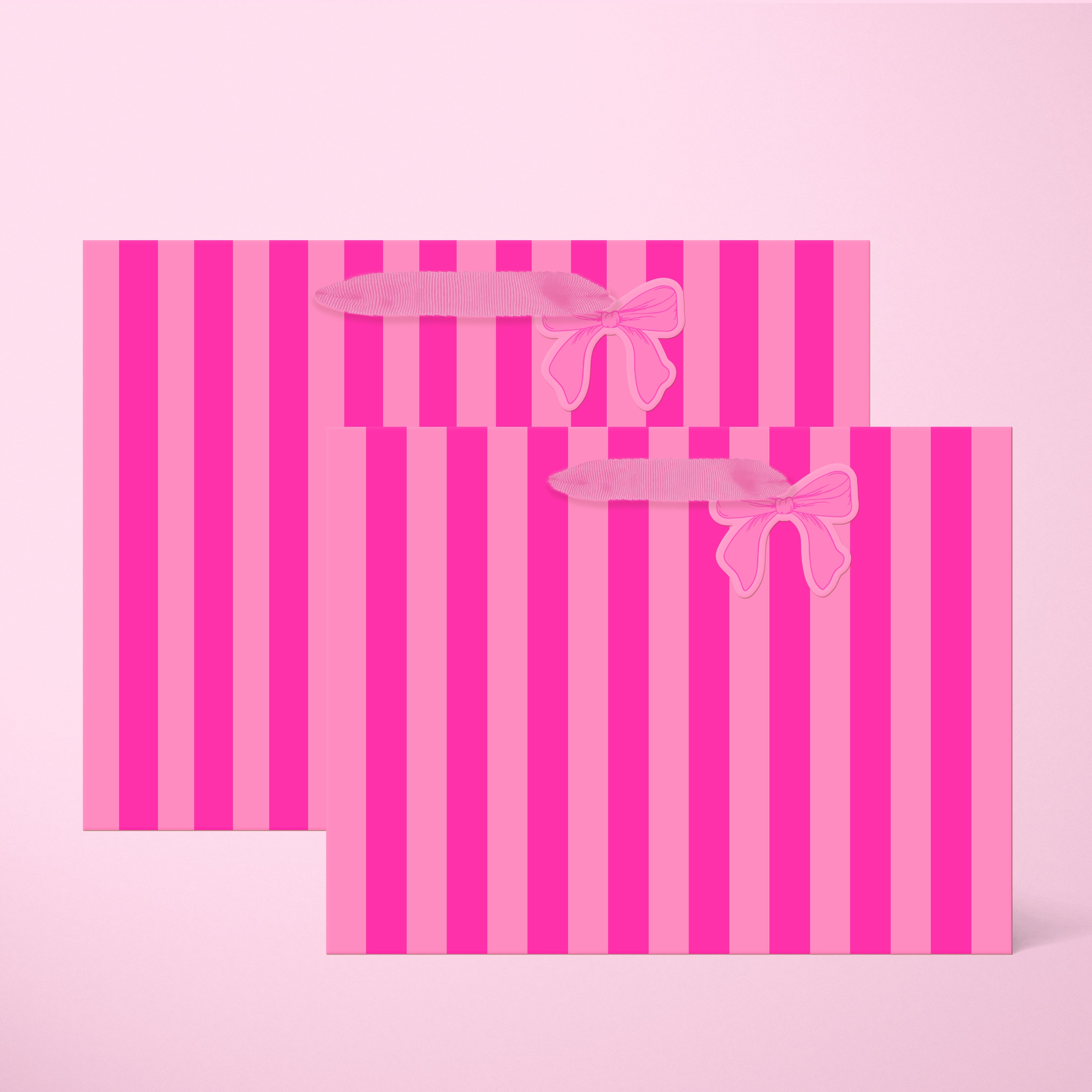 A light pink and hot pink striped gift bag in two different sizes with ribbon handles and a small bow shaped tag.