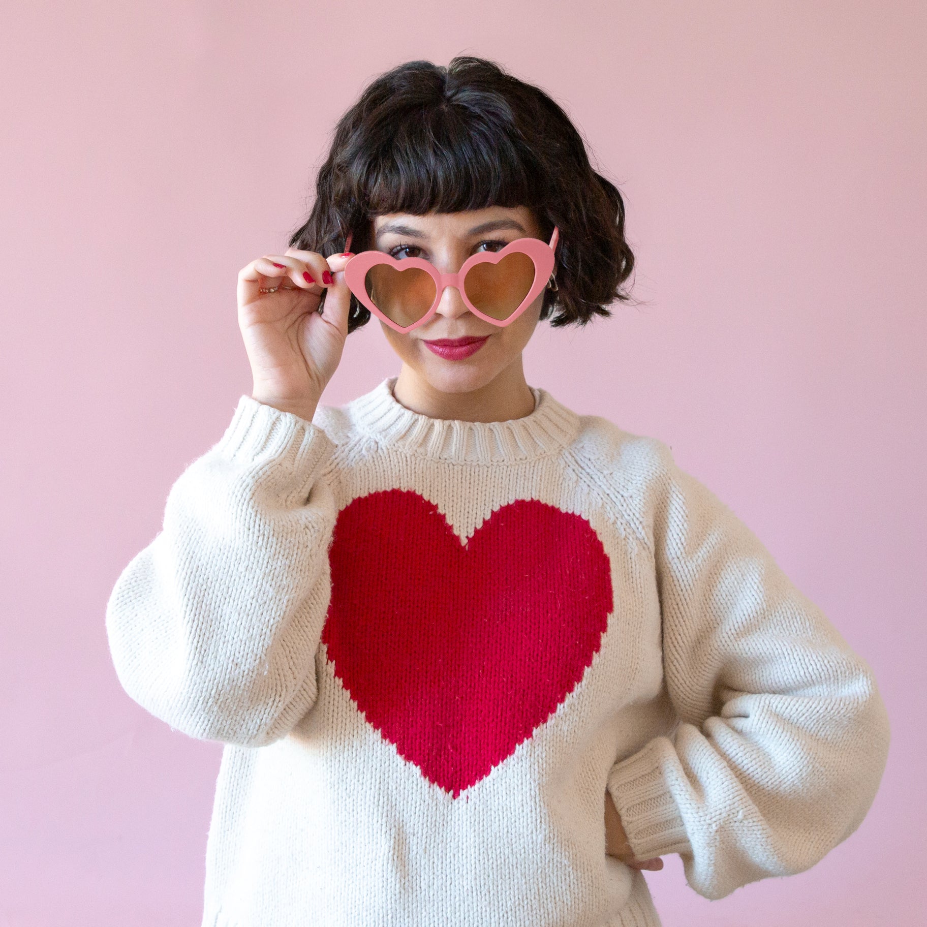 A pink heart shaped pair of sunglasses. 