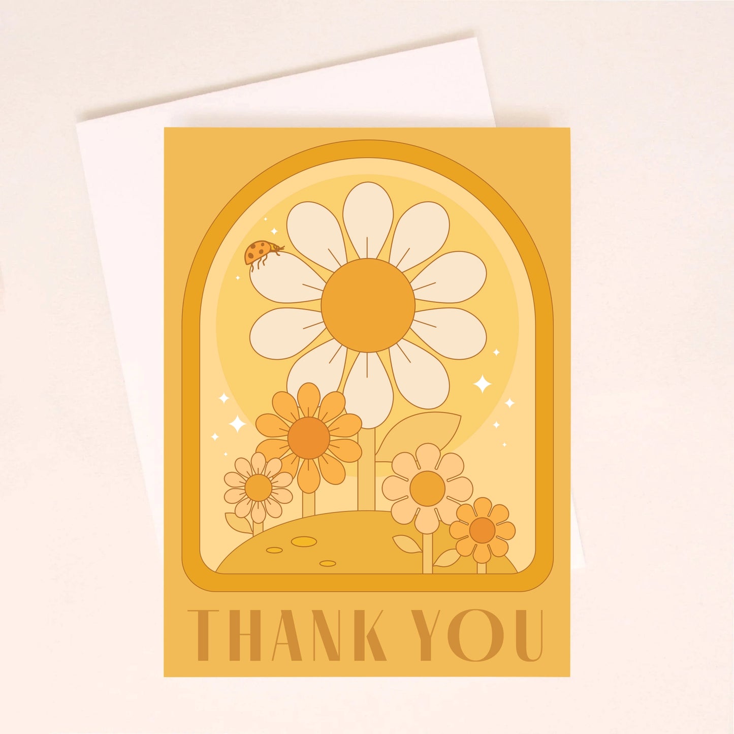 On an ivory background is an orange greeting card with an arch and daisy design with a small ladybug sitting on the largest daisy as well as dark orange text along the bottom the reads, "Thank You". 
