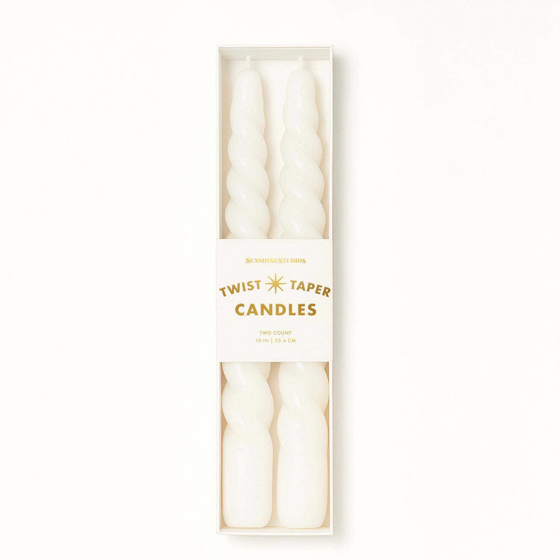 A pair of twisted white taper candles. 