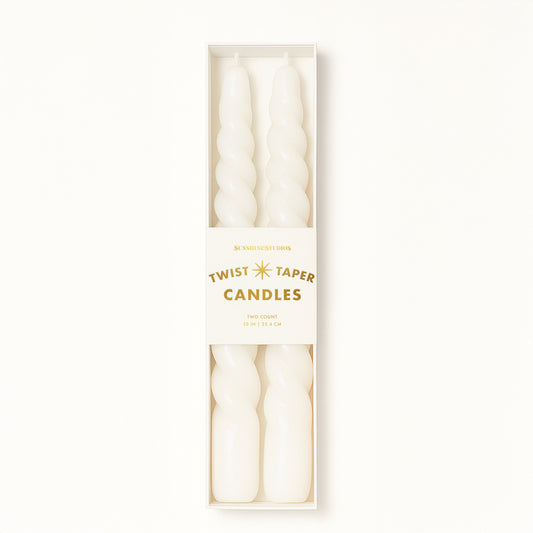 A pair of twisted white taper candles. 