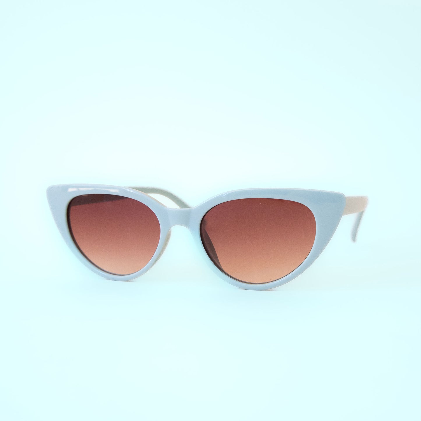 A light blue pair of cat-eye shaped sunglasses. 