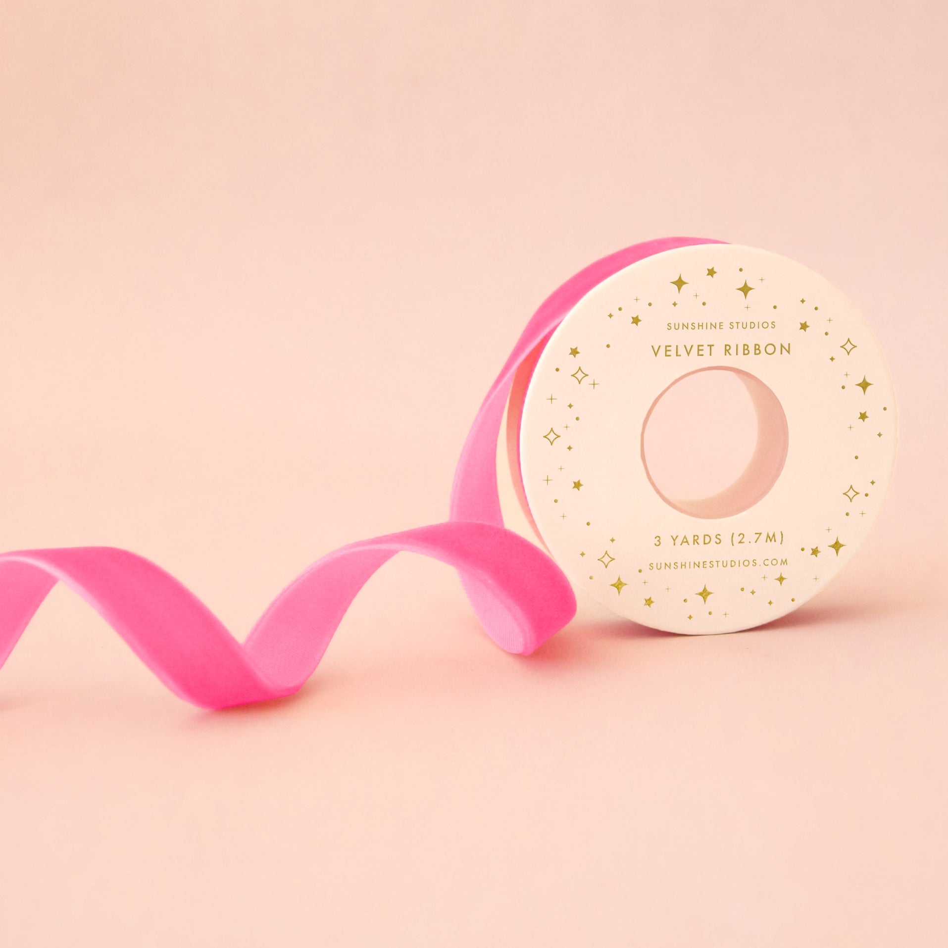 A spool of hot pink ribbon. 