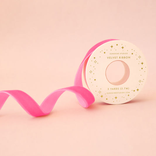 A spool of hot pink ribbon. 