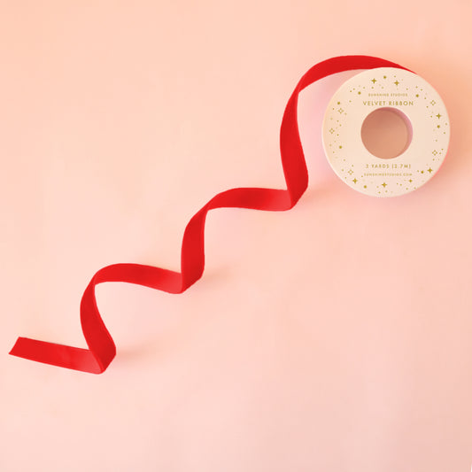 A red spool of velvet ribbon. 