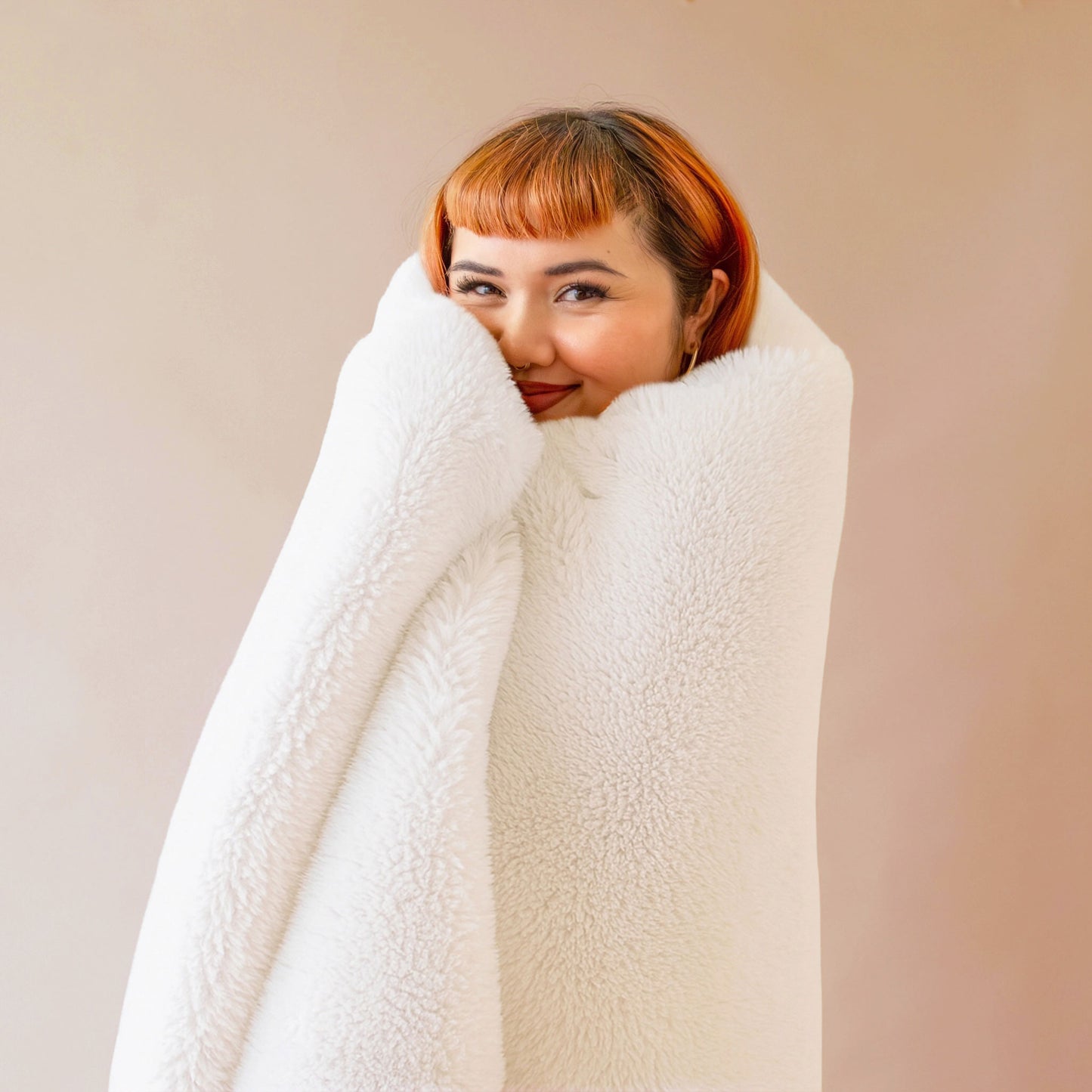 An ivory white faux fur blanket. 